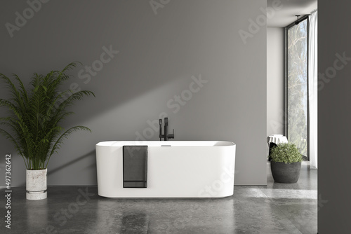 Minimalist bathroom interior with white tub on concrete floor  in front of concrete wall  interior plants  front view.  Bathroom  copy space wall. 3D rendering