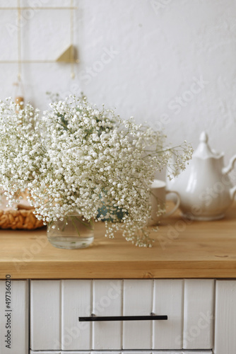 Fresh white bouquet of gypsophila flowers on a wooden table.