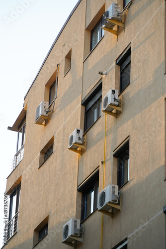 air conditioners mounted on the facade of a building.