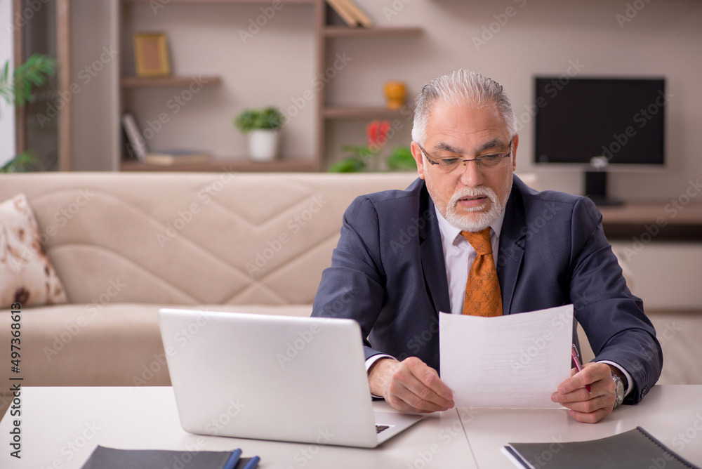 Old male employee working from home during pandemic Old male employee working from home during pandemic