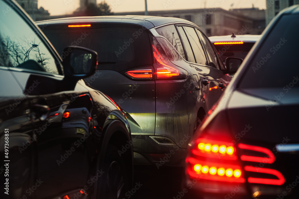 traffic. cars caught in the crowd. photo taken in the evening. people in traffic returning from work