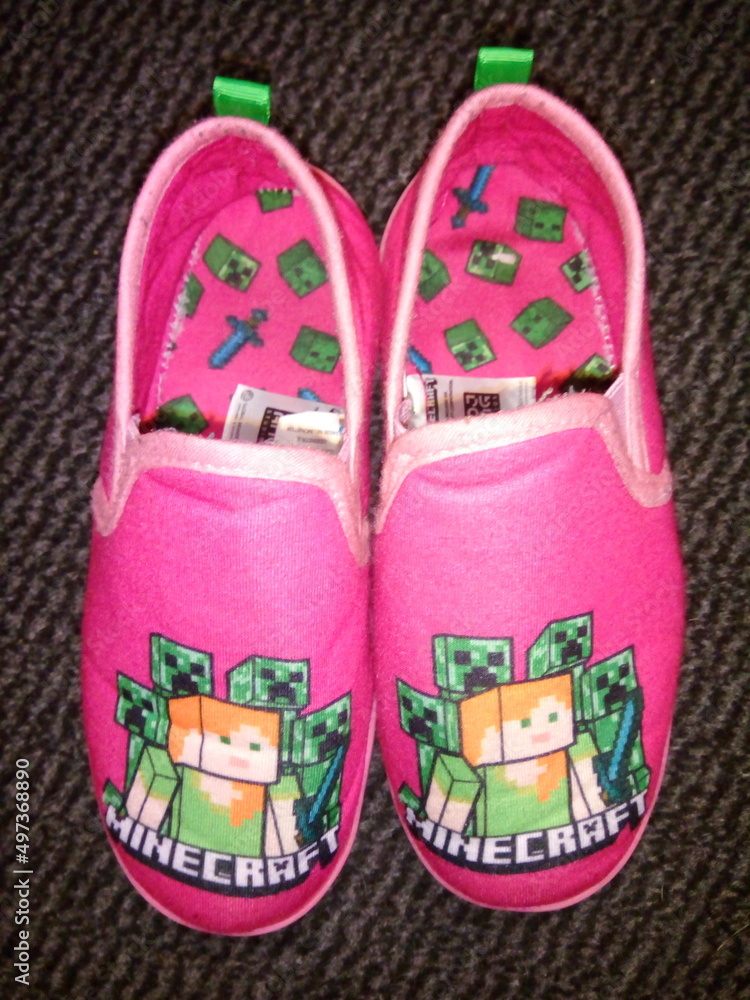 Fototapeta premium Kids pink minecraft slippers on a dark background. 06-04--2022, Lancashire, UK