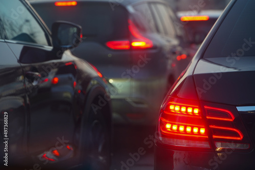 traffic. cars caught in the crowd. photo taken in the evening. people in traffic returning from work