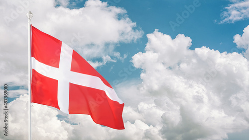 Danish flag on flagpole against cloudy sky photo