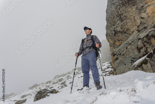 Man walking up snowy slope
