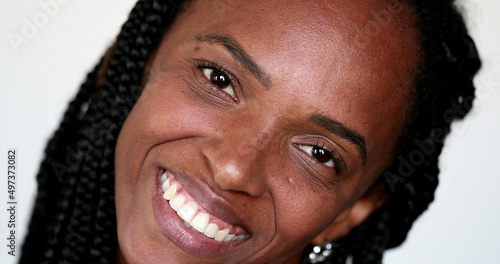 African woman covering mouth holding laughter