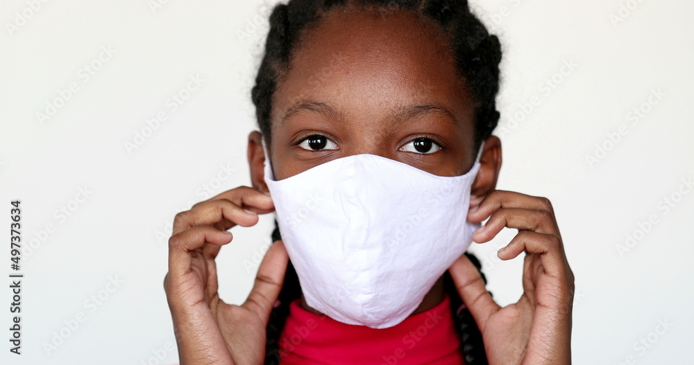 African teen girl removing covid-19 face mask African teen girl removing covid-19 face mask
