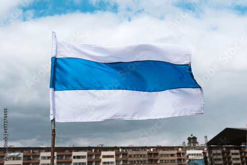 Obraz na plátně Russian new opposition white-blue-white stripped flag waving in concert for Ukraine in Prague, Czechia