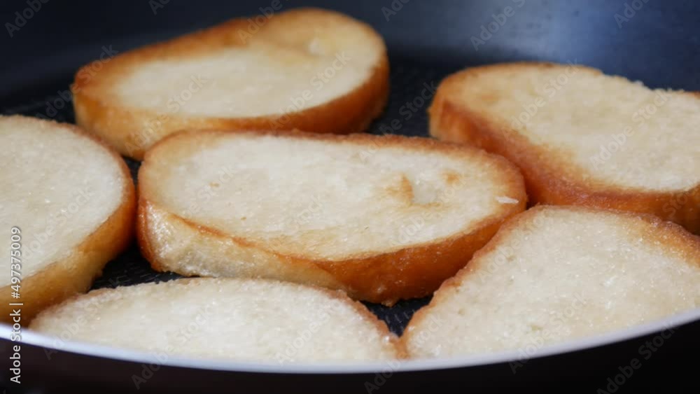 Mouth-watering fried croutons in a frying pan close-up Mouth-watering fried croutons in a frying pan close-up