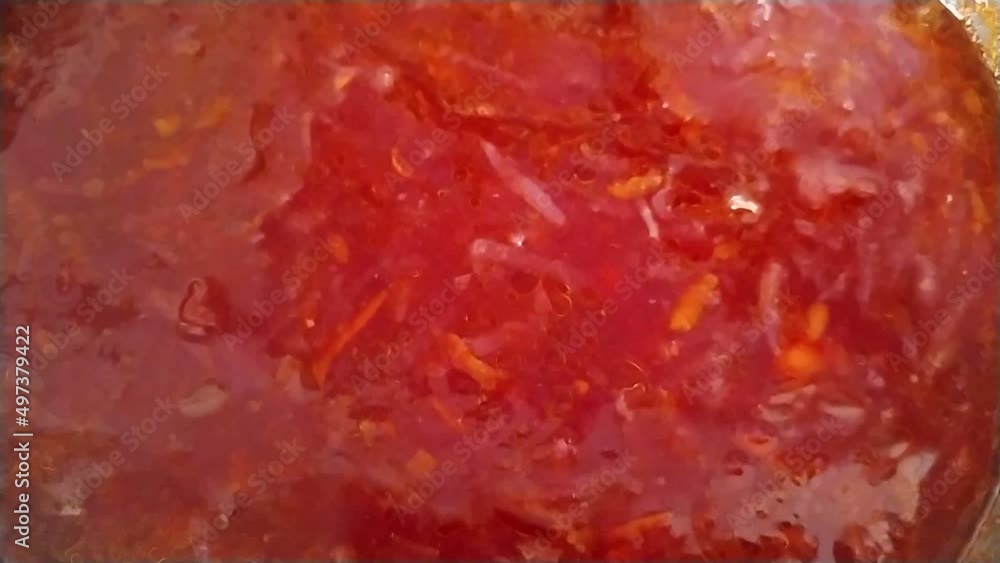 Borscht in pan close-up. Tasty red ukrainian borscht scooped up with a ladle. Homemade delicious food. Healthy tomato soup. Red borscht, soup, background. National food of Ukrainian cuisin. Borscht in pan close-up. Tasty red ukrainian borscht scooped up with a ladle. Homemade delicious food. Healthy tomato soup. Red borscht, soup, background. National food of Ukrainian cuisin.