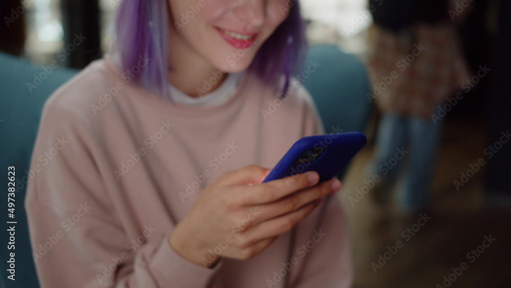 A young girl-student sits on the chair and reads humorous posts on the Internet, close up A young girl-student sits on the chair and reads humorous posts on the Internet, close up