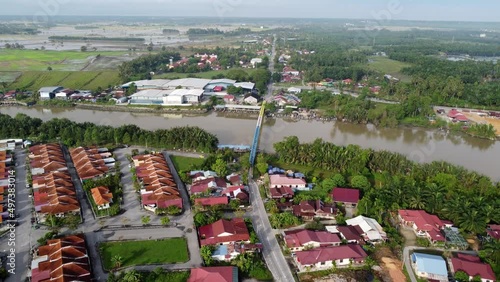 Aerial view steel iron bridge cross Kerian River near residential housing photo