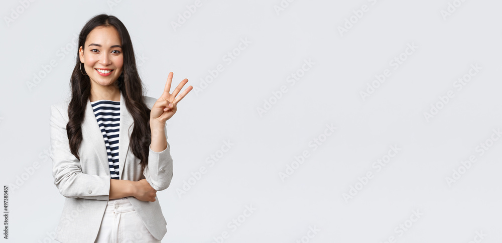 Business, finance and employment, female successful entrepreneurs concept. Successful female businesswoman, asian real estate broker pointing finger, showing number three and smiling - obrazy, fototapety, plakaty 