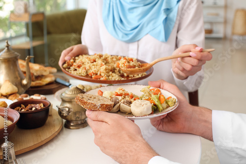 Muslim couple having breakfast together. Celebration of Eid al-Fitr
