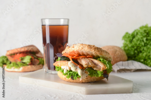 Fresh doner kebab in bun with glass of cola drink on white background