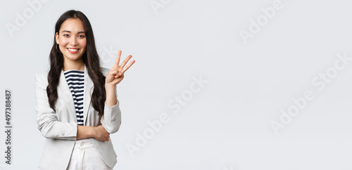 Business, finance and employment, female successful entrepreneurs concept. Successful female businesswoman, asian real estate broker pointing finger, showing number three and smiling