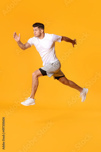 Sporty male runner on color background © Pixel-Shot