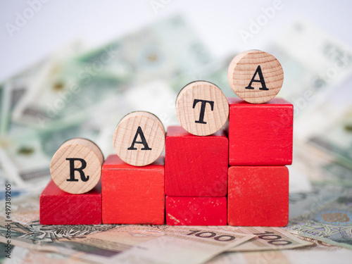 Word loan installment written in polish with wooden blocks, "rata" means loan installment
