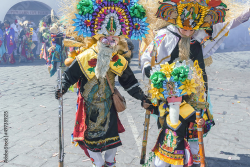 A participant in Carnival in Huejotzingo wearing traditional dress dancing. photo