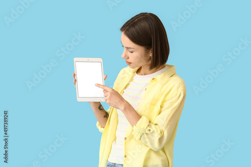 Young woman with tablet on ...