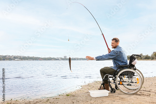 Man in wheelchair fishing o...