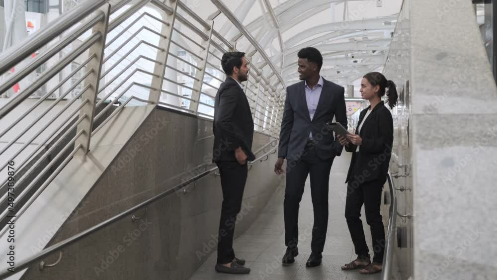 Black businessman walking and talking to businesswoman and meet business friends,so greet and talk. Black businessman walking and talking to businesswoman and meet business friends,so greet and talk.