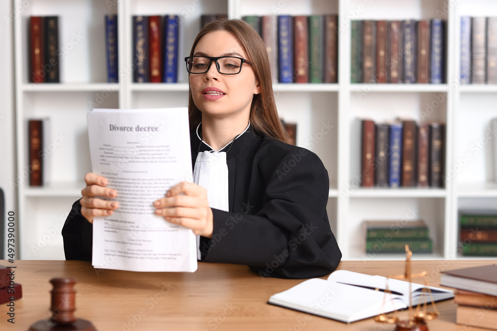 Female judge with documents at workplace in courtroom Female judge with documents at workplace in courtroom