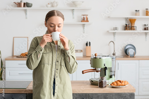 Young woman drinking tasty ...