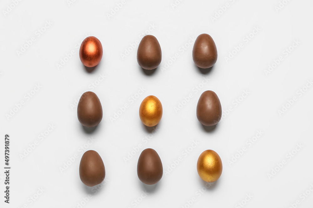 Delicious chocolate eggs on light background Delicious chocolate eggs on light background
