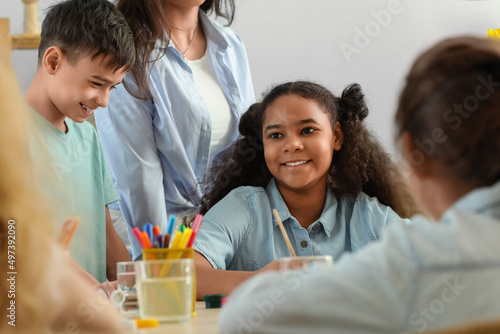 Cute children painting duri...
