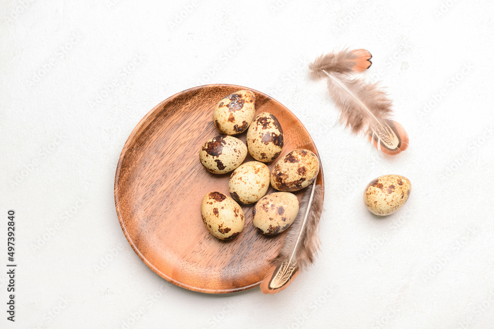 Plate with fresh quail eggs on light background Plate with fresh quail eggs on light background