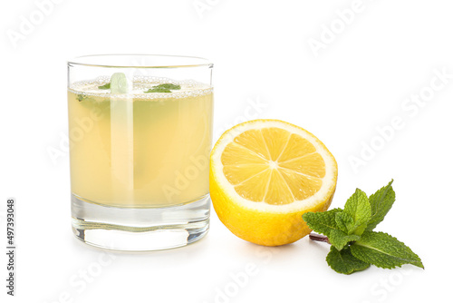 Glass with fresh lemon juice on white background