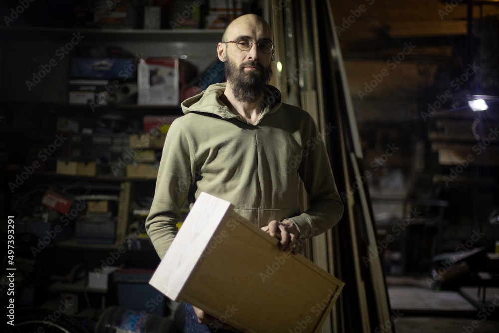 Carpenter holds drawer of planks. Wizard shows result of work. Carpenter holds drawer of planks. Wizard shows result of work.