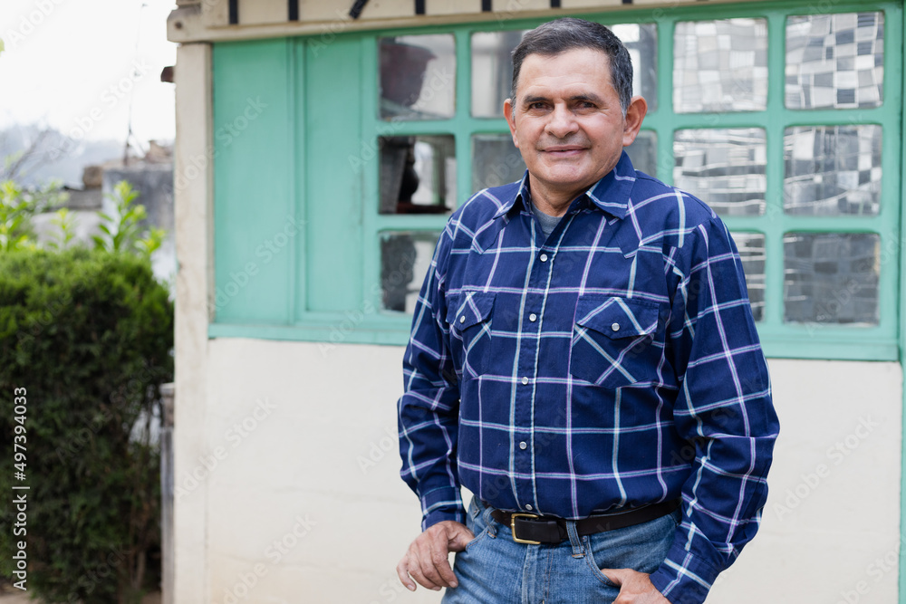 Portrait of Hispanic man in the patio of his house - Latino man in his 50s smiling Portrait of Hispanic man in the patio of his house - Latino man in his 50s smiling