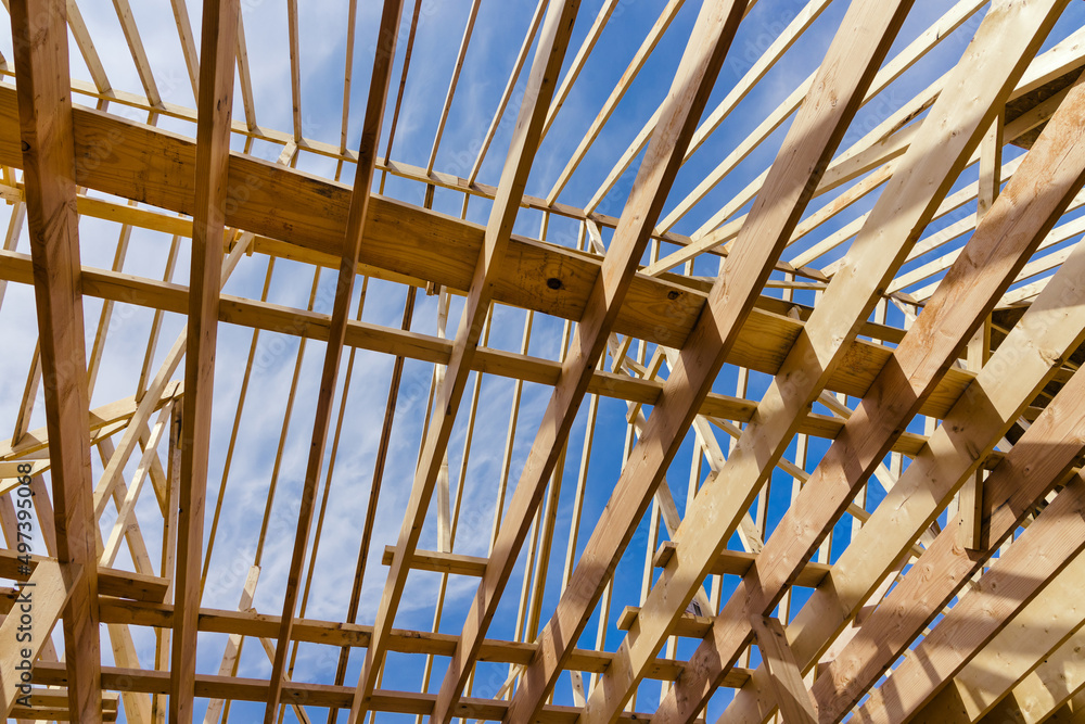 Wooden roof truss on a clear sky background Wooden roof truss on a clear sky background