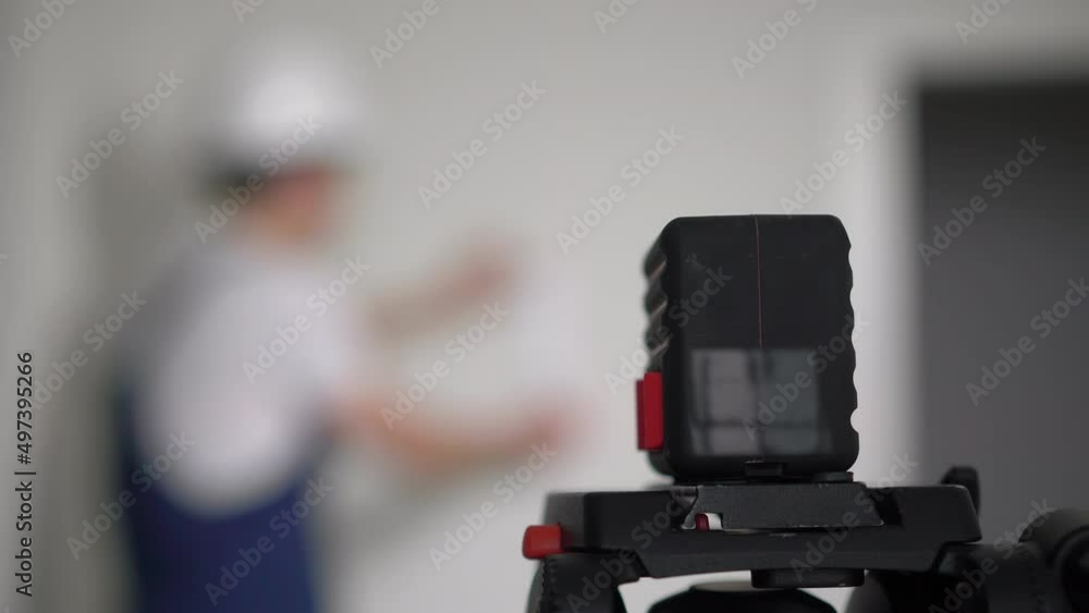 Construction laser level. Builder worker makes repairs in the apartment. Construction laser level. Builder worker makes repairs in the apartment.