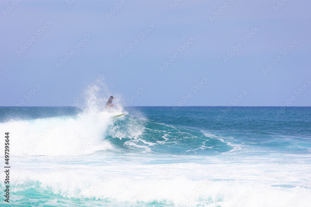 Surfer riding a wave at Banzai pipeline