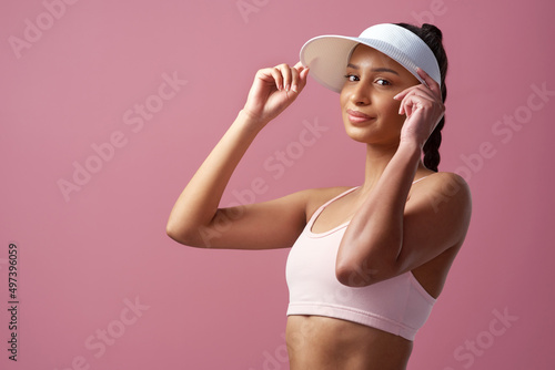Im about to crush this workout. Cropped portrait of an attractive and sporty young woman posing in studio against a pink background. © N Felix/peopleimages.com