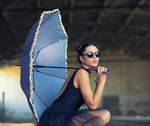 Leinwand Poster Goth ballerina holding parasol and wearing sunglasses posing in abandoned buildi