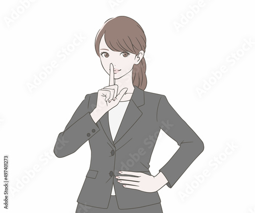 人差し指を口に当てるスーツを着た女性