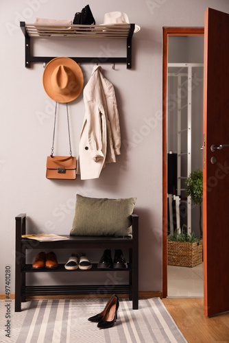 Hallway interior with stylish furniture, clothes and accessories © New Africa