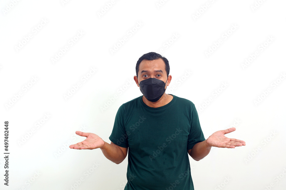 Naklejka premium Happy asian man wearing face mask standing while presenting with both hand. Isolated on white