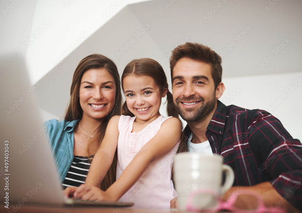 Shes ready for a lesson in wireless technology. Portrait of a happy married couple and their young daughter using a laptop together at home. Shes ready for a lesson in wireless technology. Portrait of a happy married couple and their young daughter using a laptop together at home.