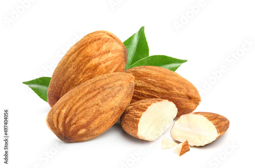 Almonds with cut in half and green leaves isolated on white background.