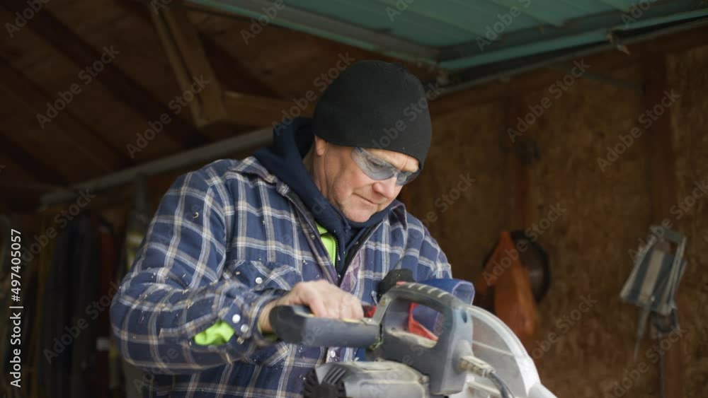 A man cuts a piece of wood with a table saw and measures it after. A man cuts a piece of wood with a table saw and measures it after.