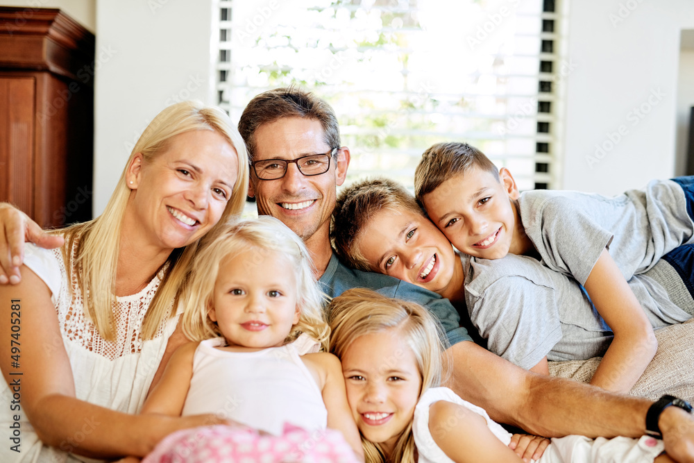 Together is when were happiest. Portrait of a happy family spending quality time together at home.