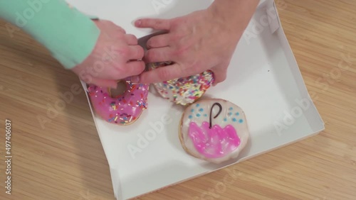Top view like people take donuts out of the box on a table