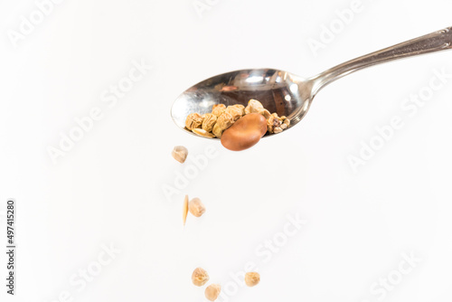 spoon with moving seeds falling down, to plant in mother earth, earth day concept, copy space, close up