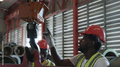 Engineering and worker training or explaining detail weight overhead cranelifting machine, two engineer checking the operation of crane in the factory, recruitment concept photo