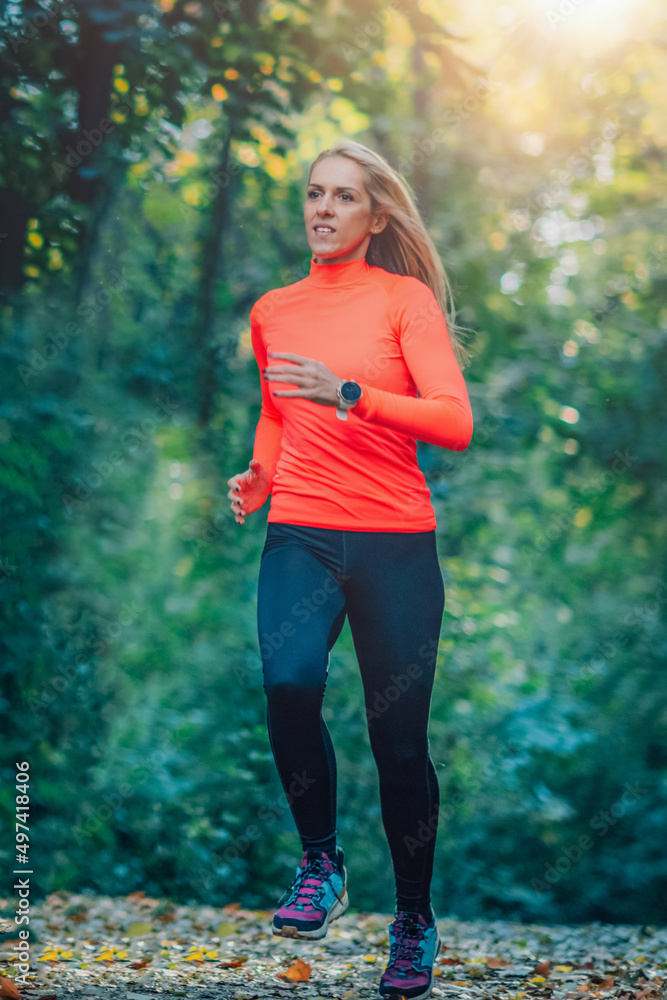 Woman Running in Public Park in the Fall. Woman Running in Public Park in the Fall.